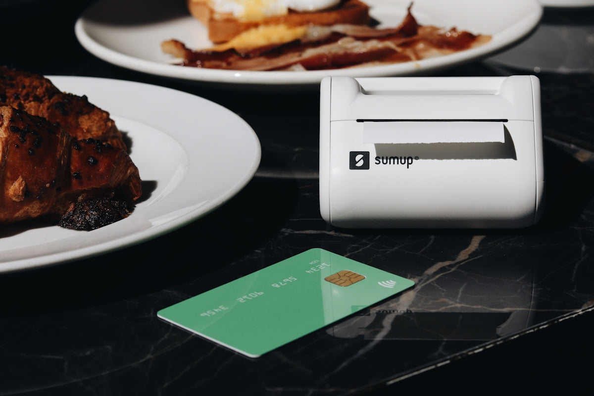 A table topped with plates of food and a credit card
