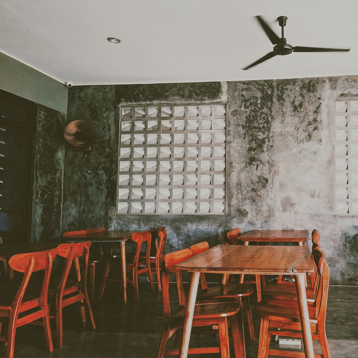 Empty cafe with wooden tables and chairs